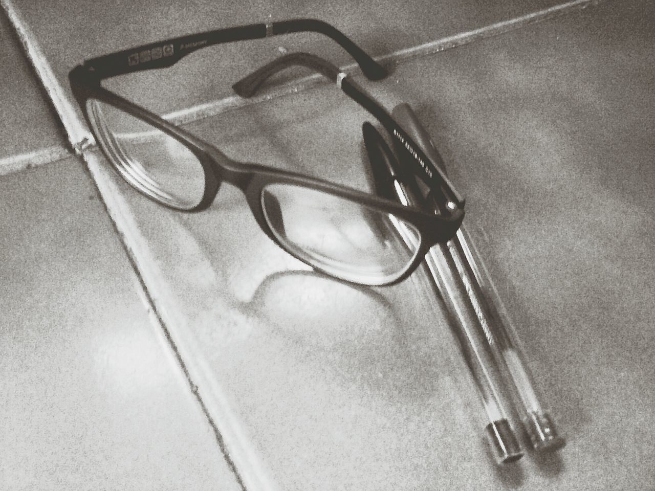 indoors, still life, high angle view, close-up, metal, one person, table, single object, handle, technology, part of, directly above, shadow, wall - building feature, fashion, connection, domestic bathroom, eyeglasses, absence