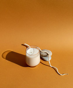 Close-up of tea cup on table against wall