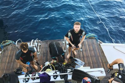 Friends sitting on boat in sea