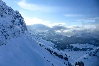 Scenic view of mountains against sky during winter