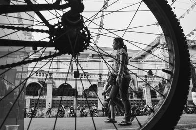 Low angle view of woman with umbrella against sky