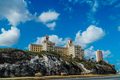 Low angle view of historical building against cloudy sky