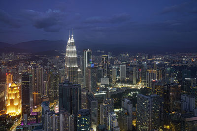 Aerial view of illuminated buildings in city at night