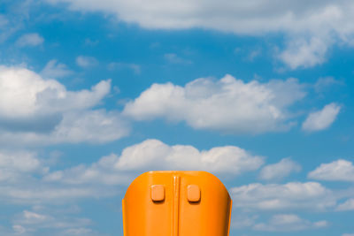 Low angle view of yellow toy against sky