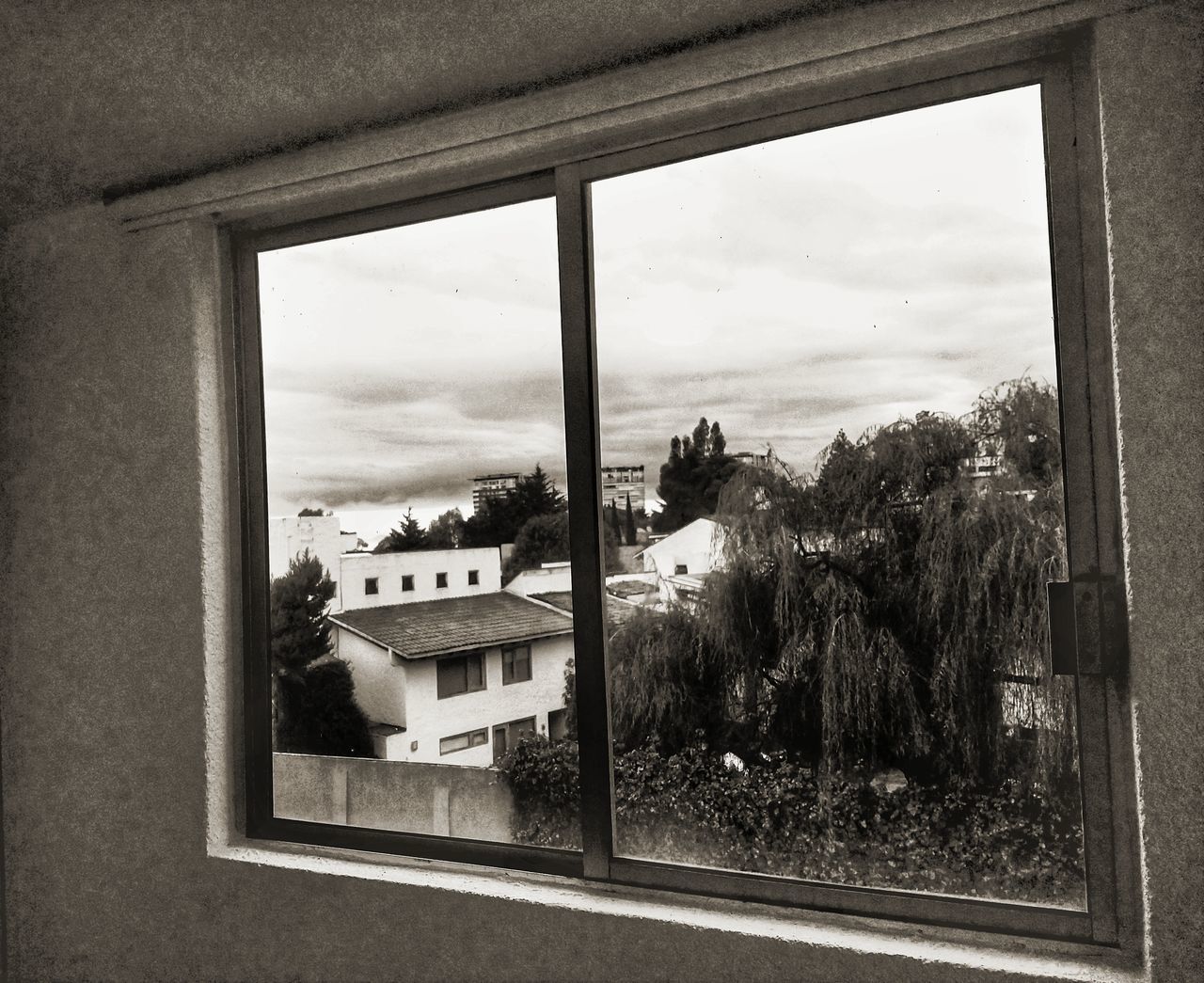 BUILDINGS SEEN THROUGH WINDOW OF HOUSE