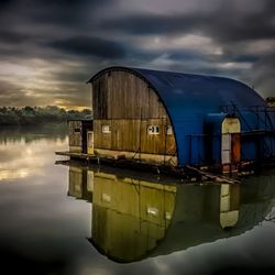 Reflection of built structures in calm lake