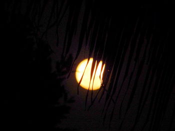 Close-up of illuminated light in dark room