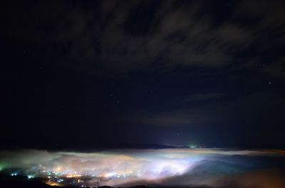 Scenic view of landscape against sky at night