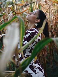 Rear view of woman looking away outdoors