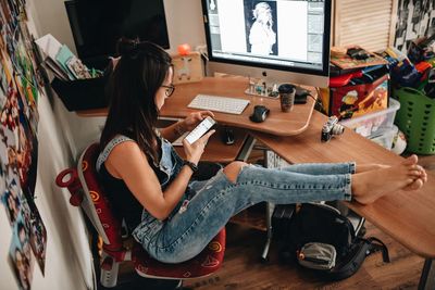 Woman sitting on table at home