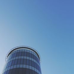 Low angle view of modern building against clear blue sky