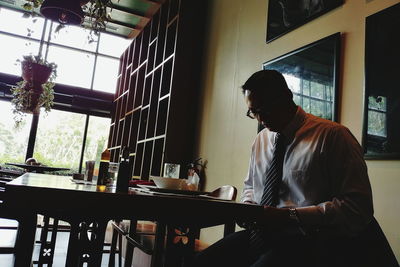 Man sitting on table at cafe