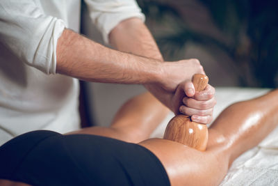 Midsection of man giving massage to woman