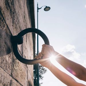 Low angle view of hand holding sun