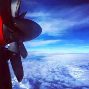 Midsection of man on airplane against sky