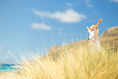 Woman on beach against sky