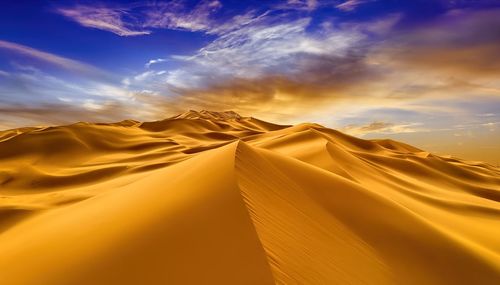 Sunset over the sand dunes in the desert. arid landscape of the sahara desert