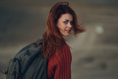 Portrait of beautiful young woman standing outdoors