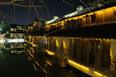 Reflection of illuminated bridge in water at night