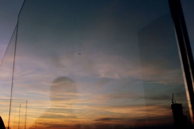 Low angle view of sky seen through glass window