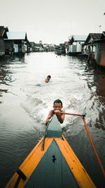 Man in boat on sea against sky