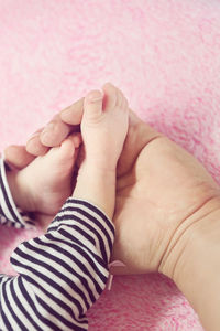 Close-up of hands holding baby hand