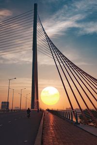 View of suspension bridge against sky during sunset