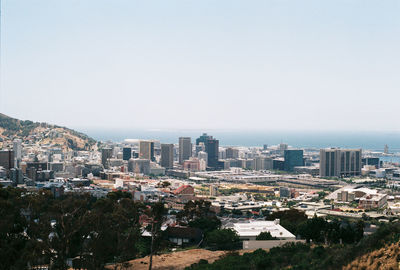 High angle view of buildings in city against clear sky