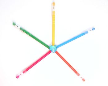 Close-up of colored pencils against white background