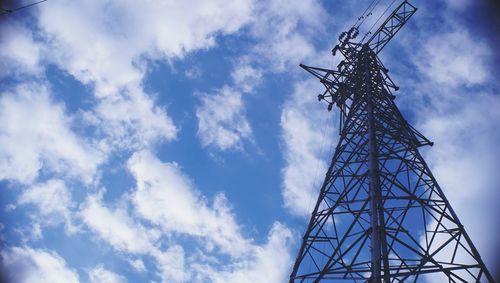 Low angle view of electricity pylon against sky