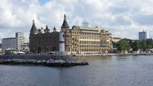 Buildings in city against cloudy sky