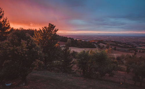 Scenic view of townscape against sky at sunset