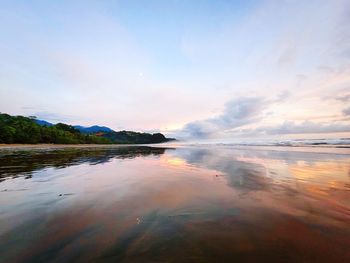 Scenic view of lake against sky at sunset