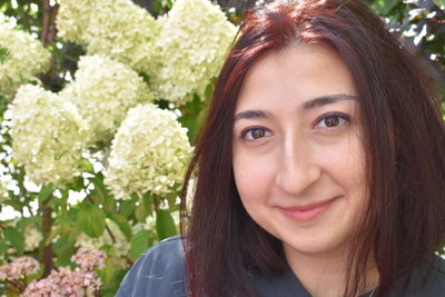 Close-up portrait of smiling woman in garden 