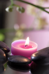 Close-up of illuminated candles on table