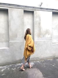 Full length of woman with yellow umbrella
