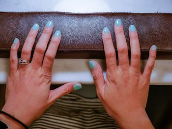 Midsection of woman hand on wall