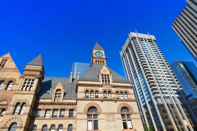 Low angle view of buildings against blue sky