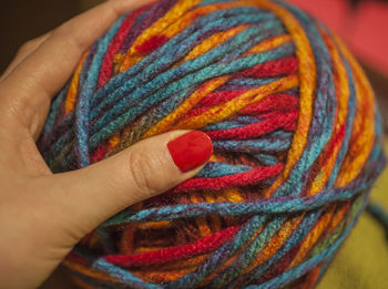 A hand with a ball of yarn