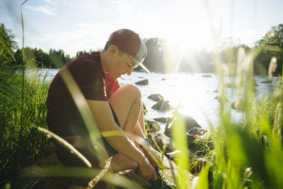 Young man at camping at lakeside