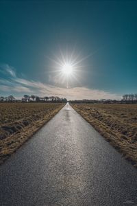 Tire tracks on road against sky