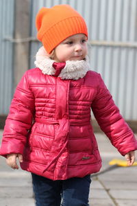 Portrait of cute girl standing in snow