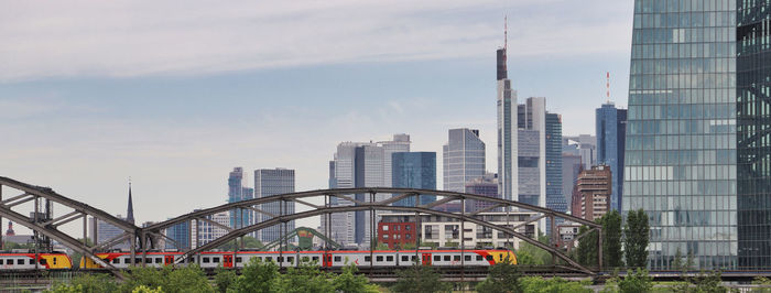 View of city buildings in frankfurt against cloudy sky