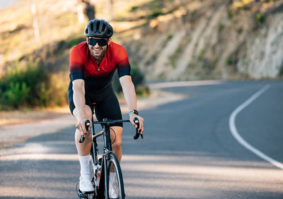 Man riding bicycle on road