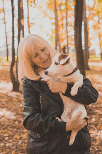 Midsection of woman with dog on land