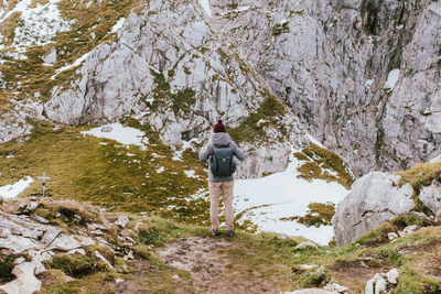 Rear view of man standing on rock