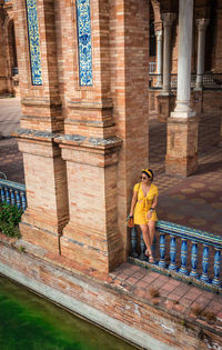 Woman with umbrella on the wall of a building