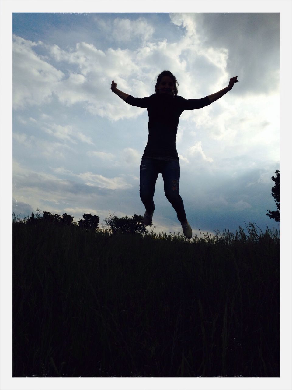 sky, full length, field, standing, lifestyles, cloud - sky, leisure activity, silhouette, transfer print, cloud, auto post production filter, arms raised, arms outstretched, landscape, nature, tranquility, outdoors, tranquil scene