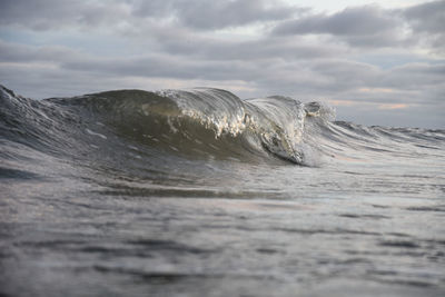 Scenic view of sea waves against sky