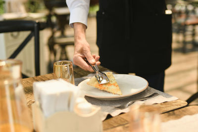 Midsection of man preparing food on table